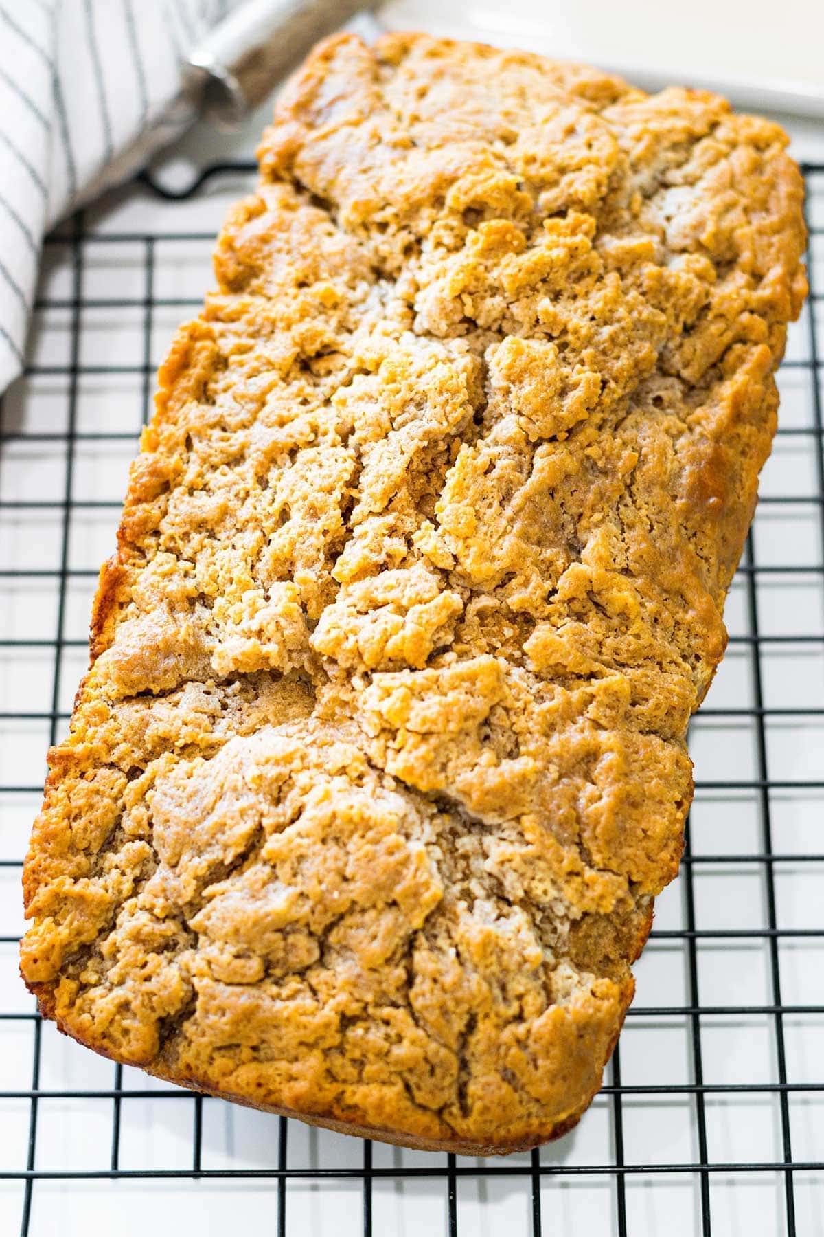 Loaf of buttery bead bread on a cooling rack.