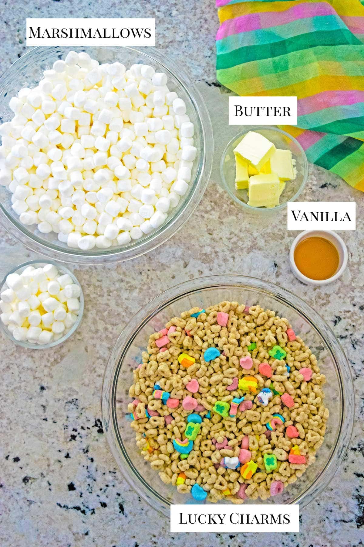 Picture of ingredients for Lucky Charms treats - marshmallows, butter, vanilla extract, and Lucky Charms cereal.