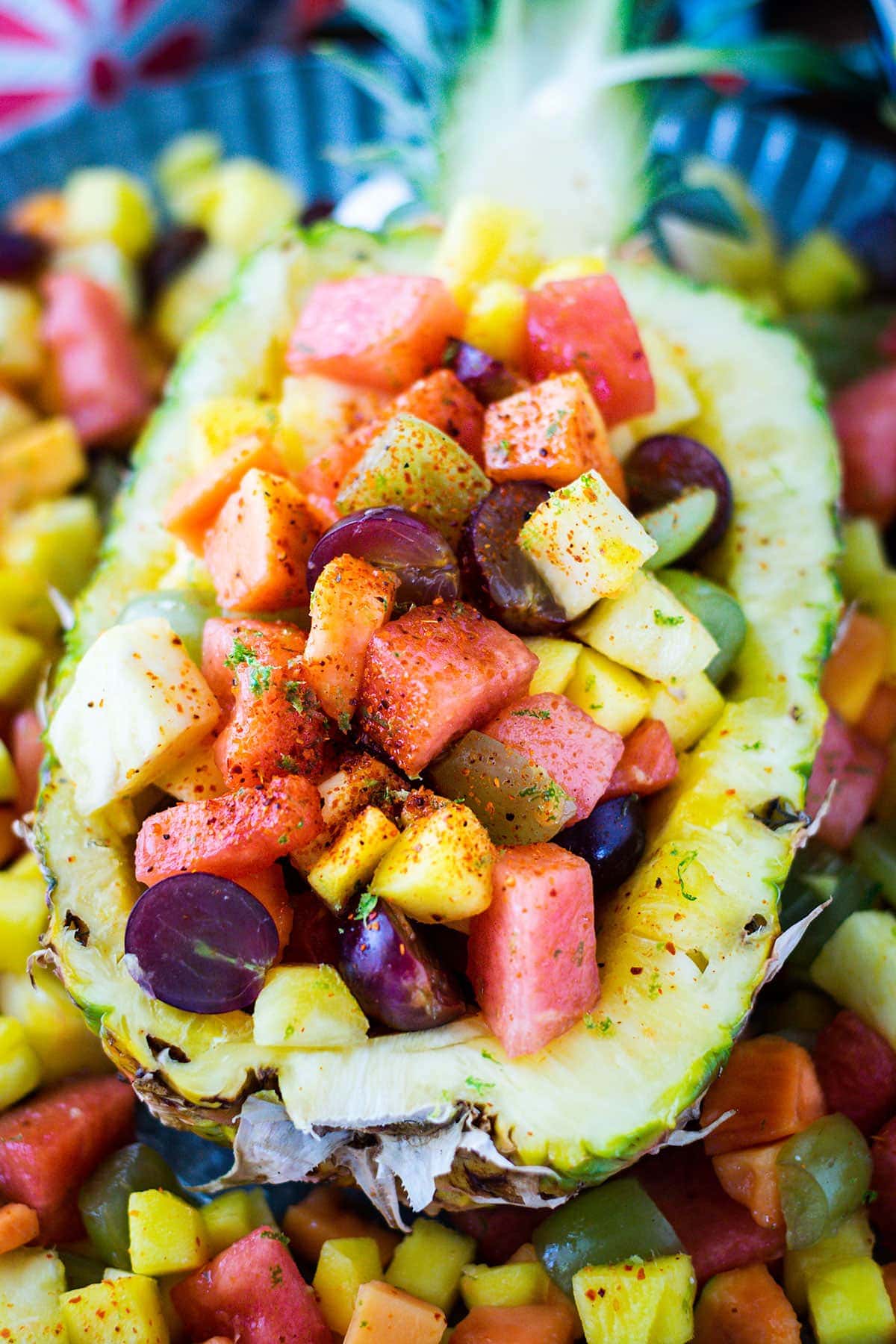 Up close picture of half pineapple filled with Mexican fruit salad.