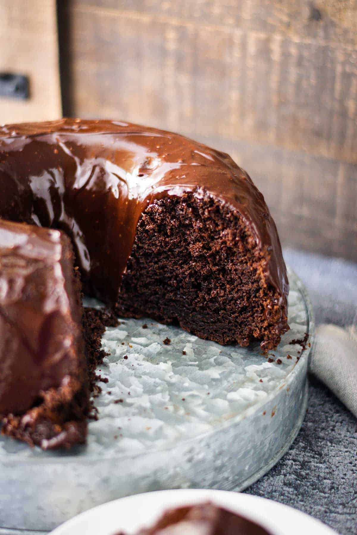 Chocolate Brownie Bundt cake on a galvanized cake server.