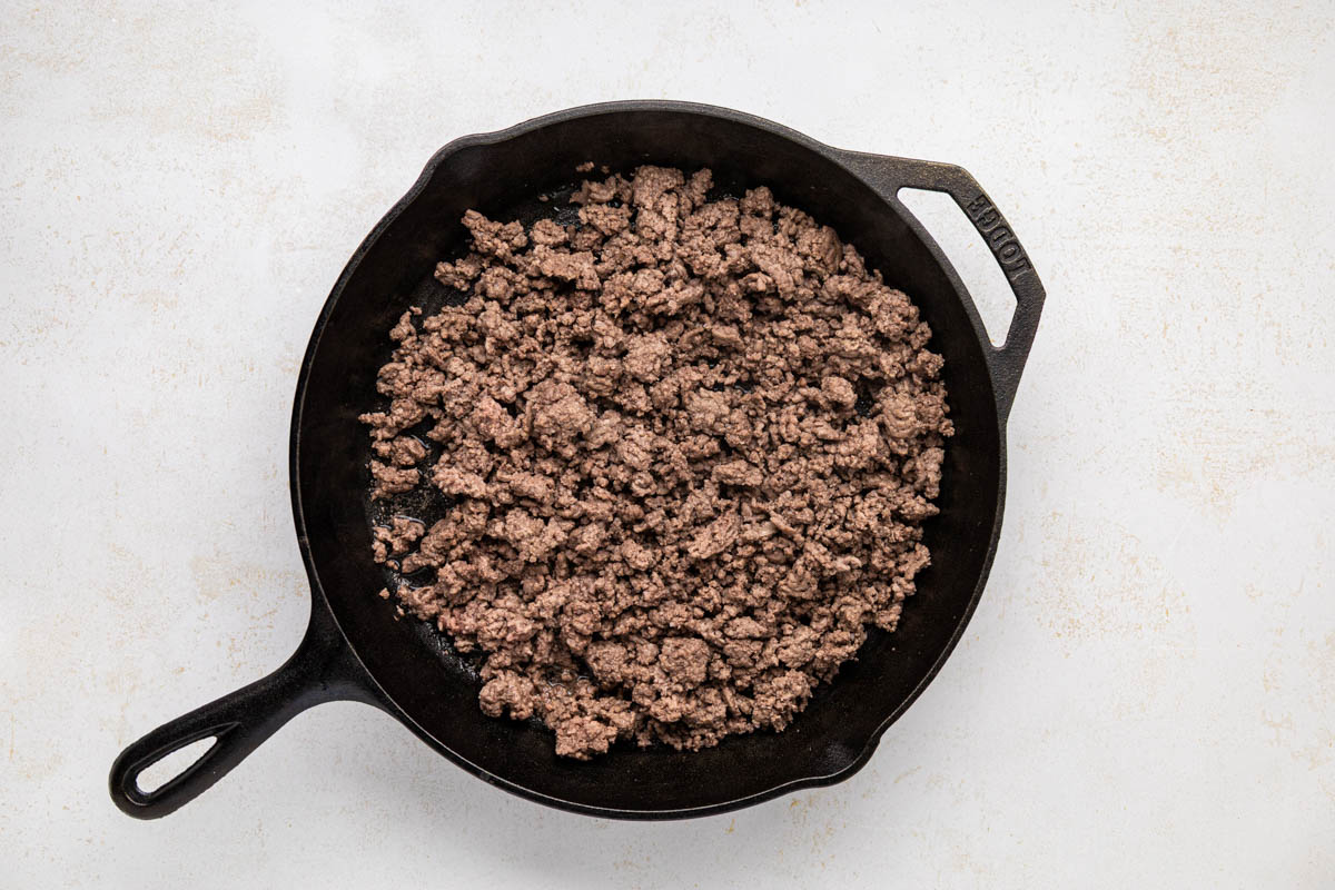 Cooked ground beef in a cast iron skillet.