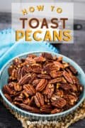 Pinterest image showing toasted pecans in a blue bowl.