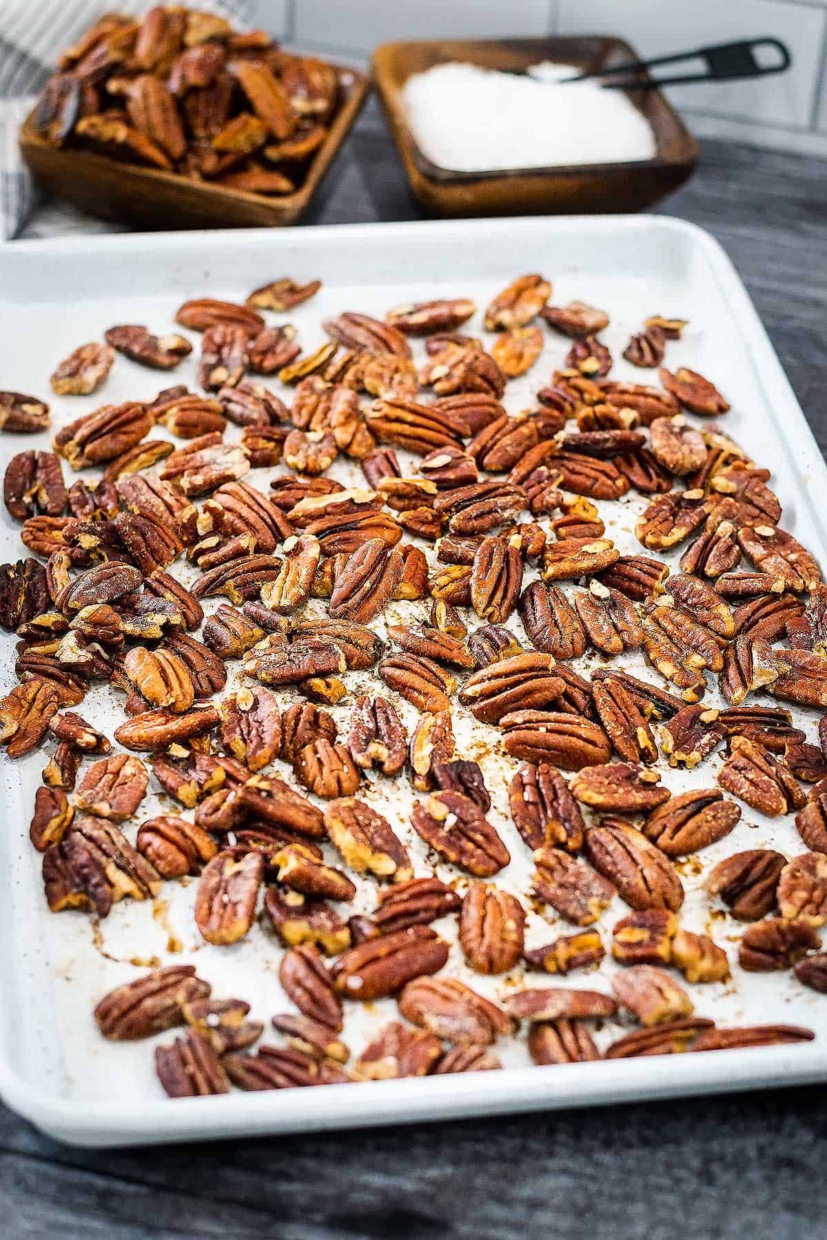 Roasted pecans fresh out of the oven on a baking tray.