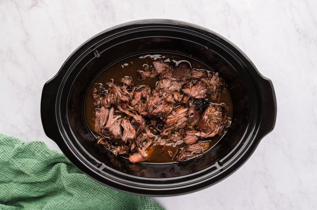 Three packet pot roast back in the slow cooker with gravy .