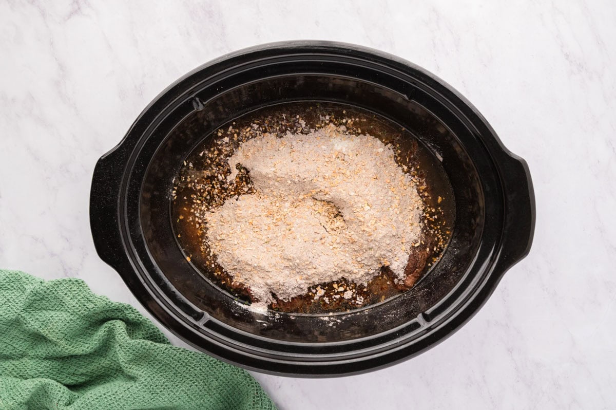 All 3 packets sprinkled even on top of the chuck roast in the slow cooker