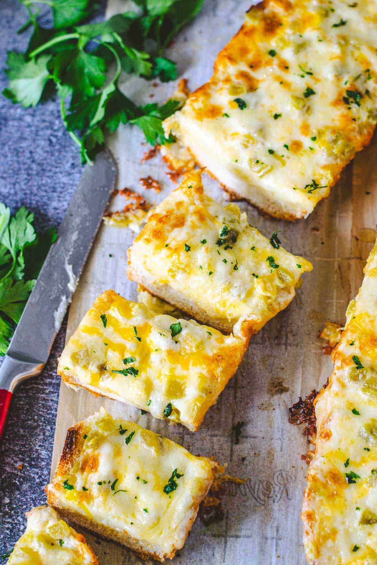 Up close image of sliced cheesy green chile bread.