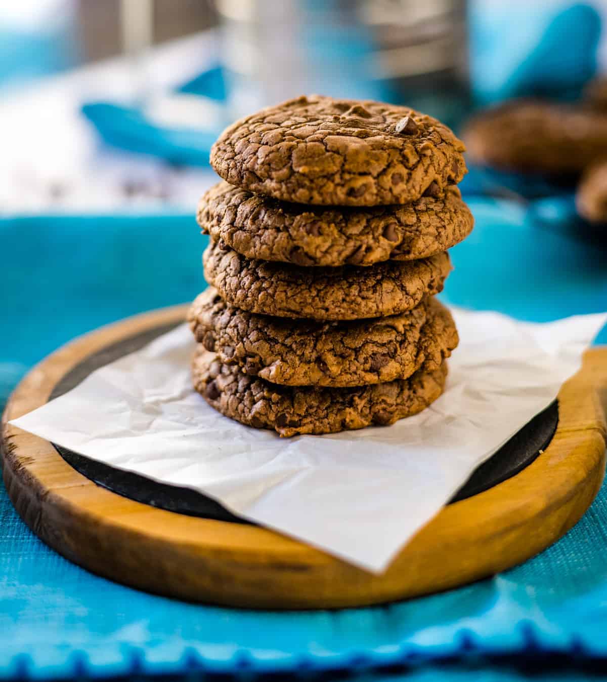 Stacked brownie mix cookies with blue background.