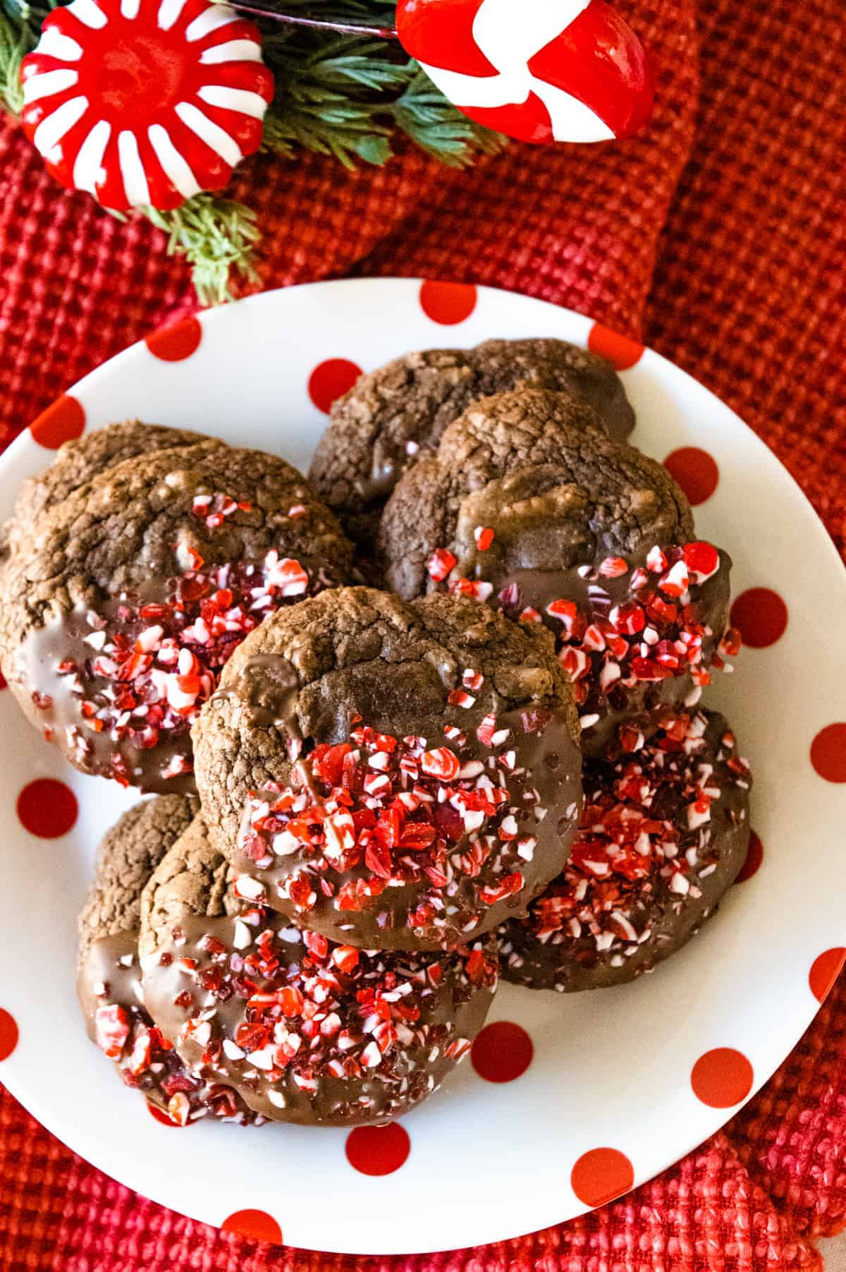 Peppermint Brownie Mix Cookies stacked on a white plate with red polka dots. 