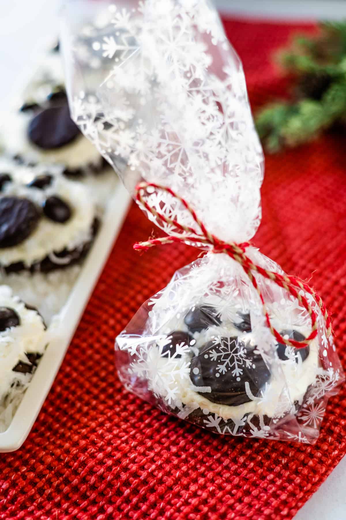 Individual gift wrapped polar bear paw cookie tied with red and tan twine.