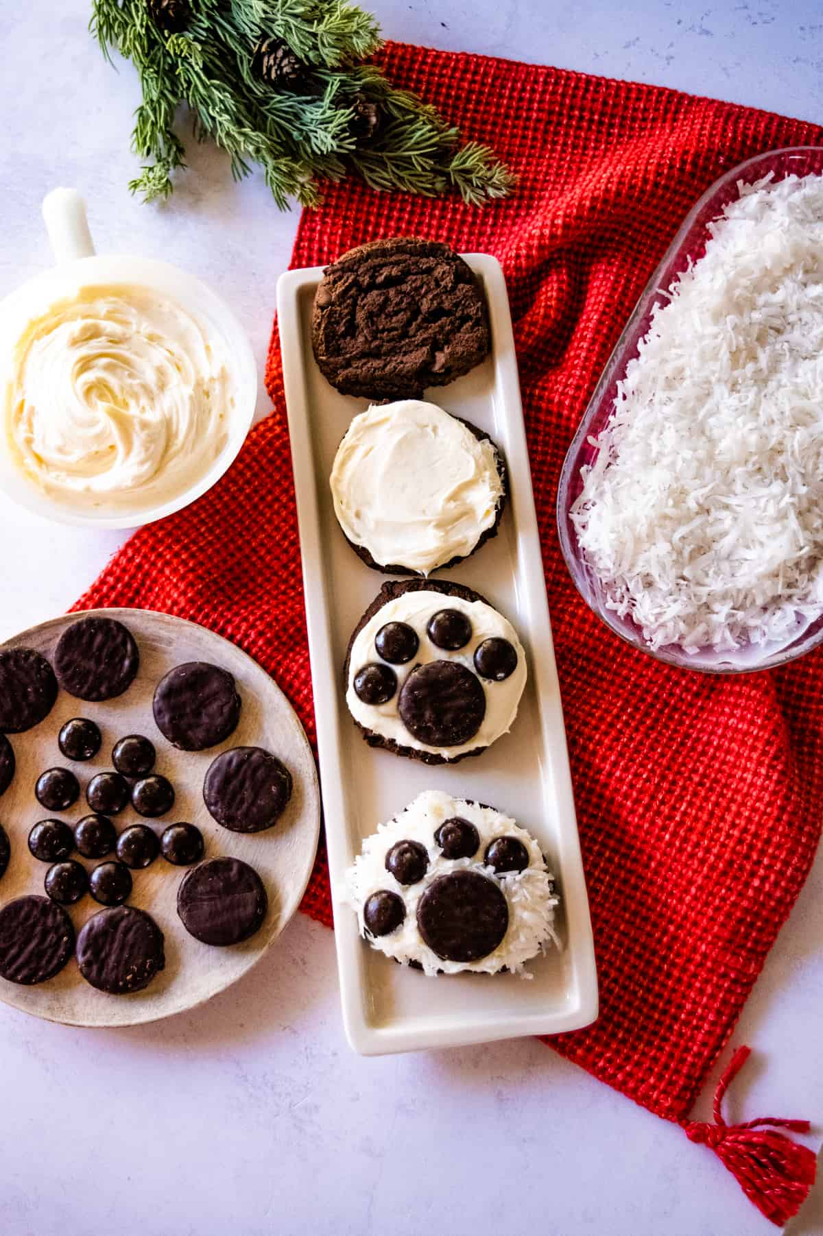 Polar Bear Paw Cookies on a tray showing steps in putting cookies together.