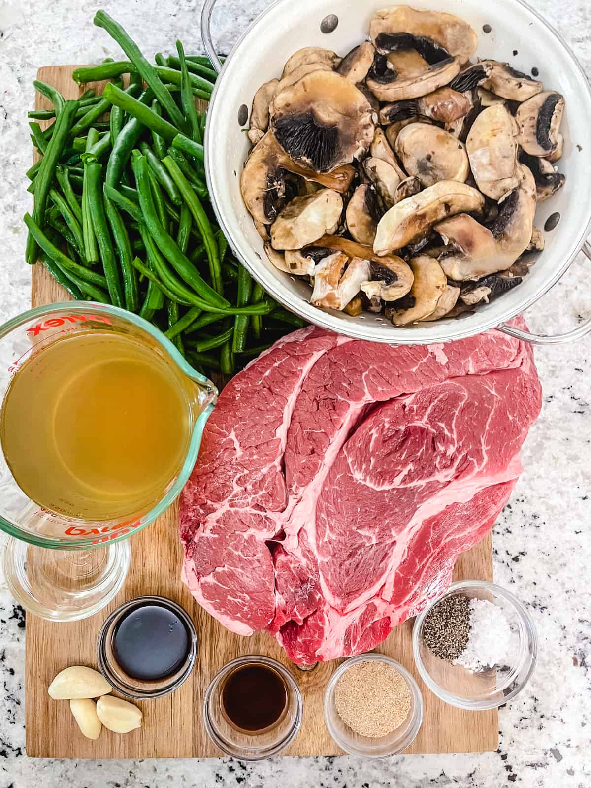 Ingredients needed for a pot roast made with mushrooms and green beans.