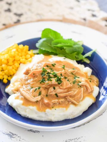 Slow Cooker Chicken and Gravy on a blue plate