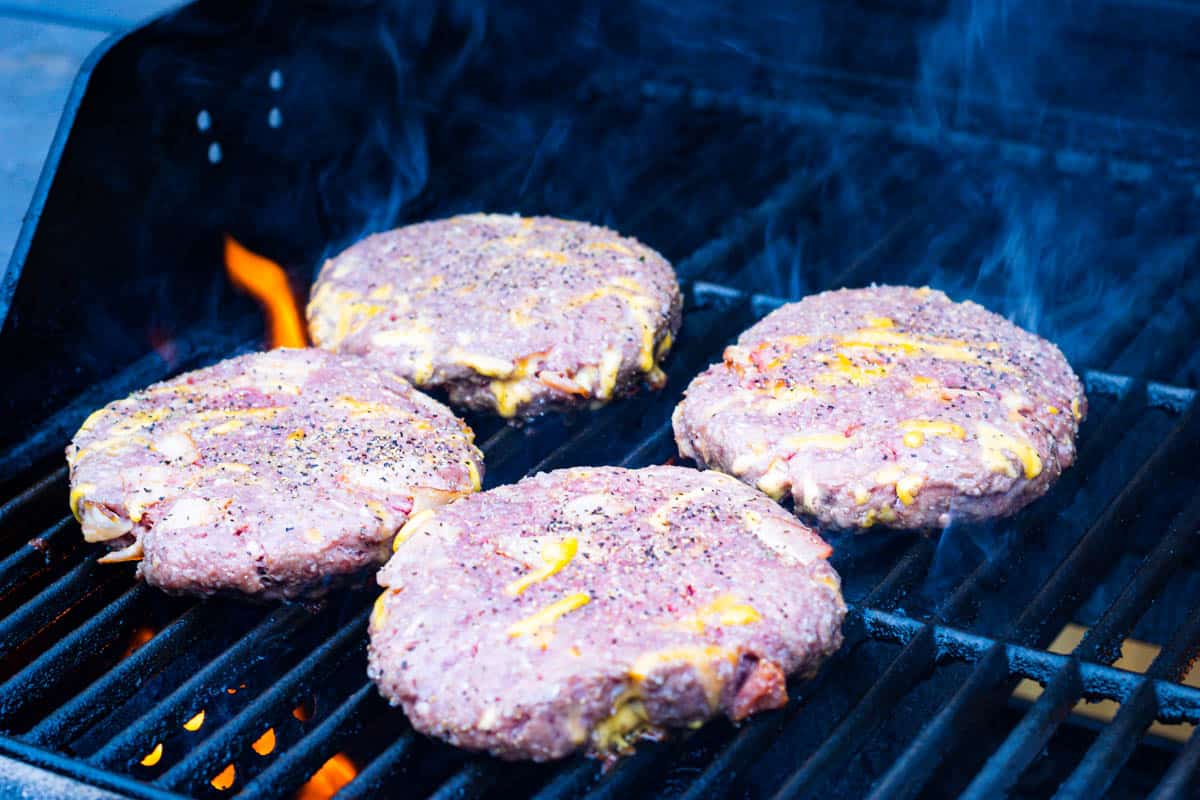 Stuffed bacon cheddar patties as they are just put on the grill to cook.