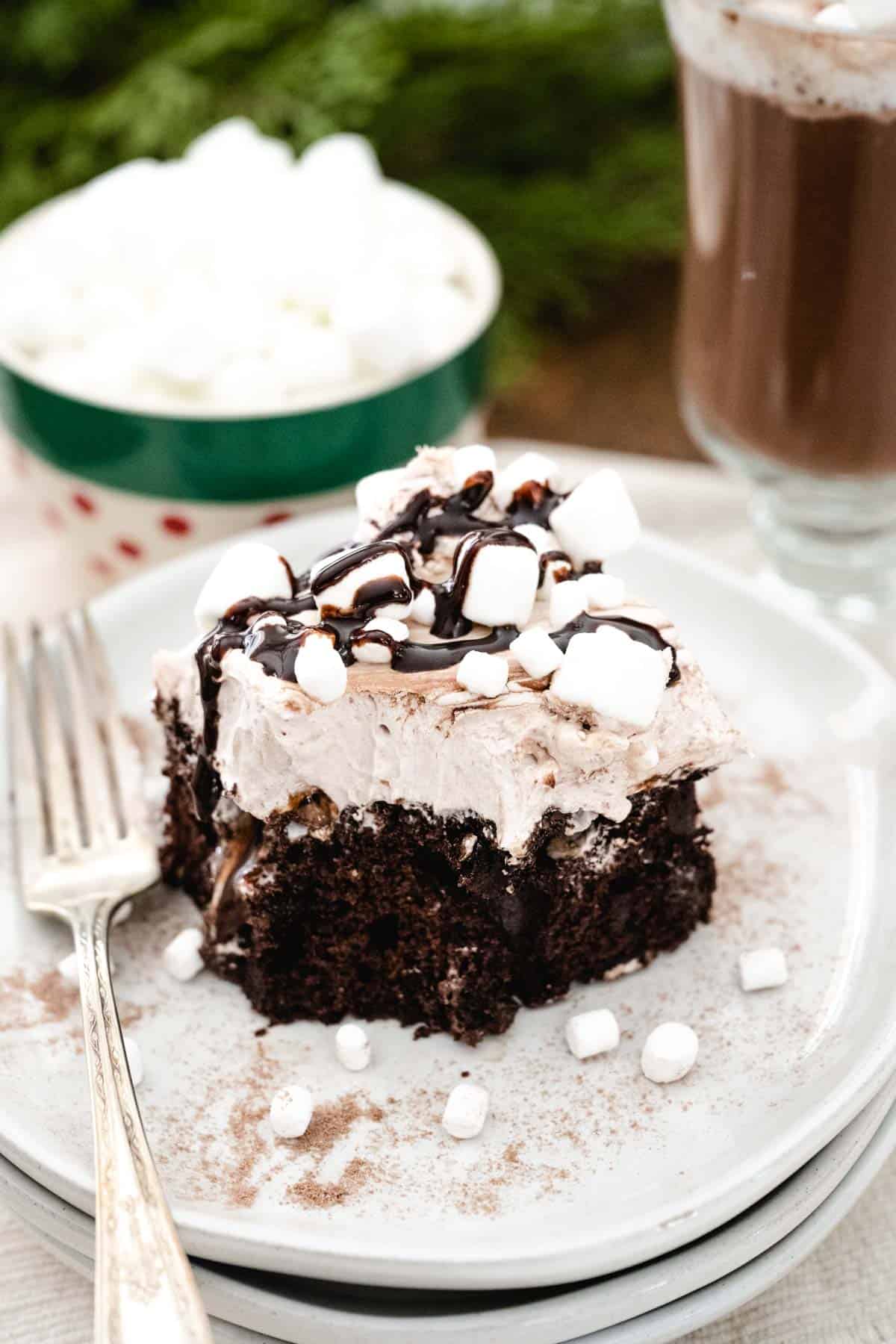 Hot chocolate cake on a plate with a bite taken from the cake.