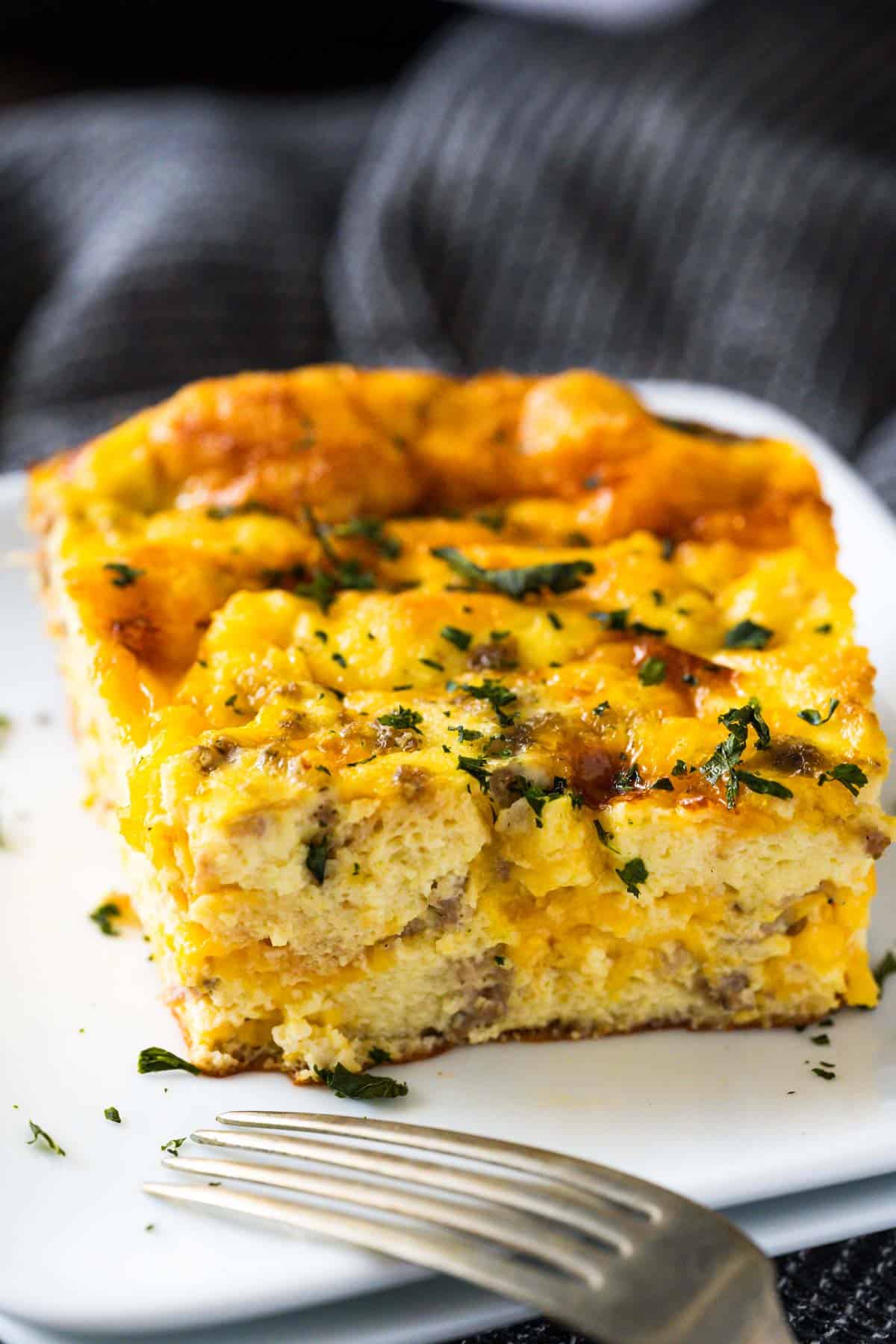 Upclose image of overnight breakfast casserole featuring the fluffy texture of the souffle.