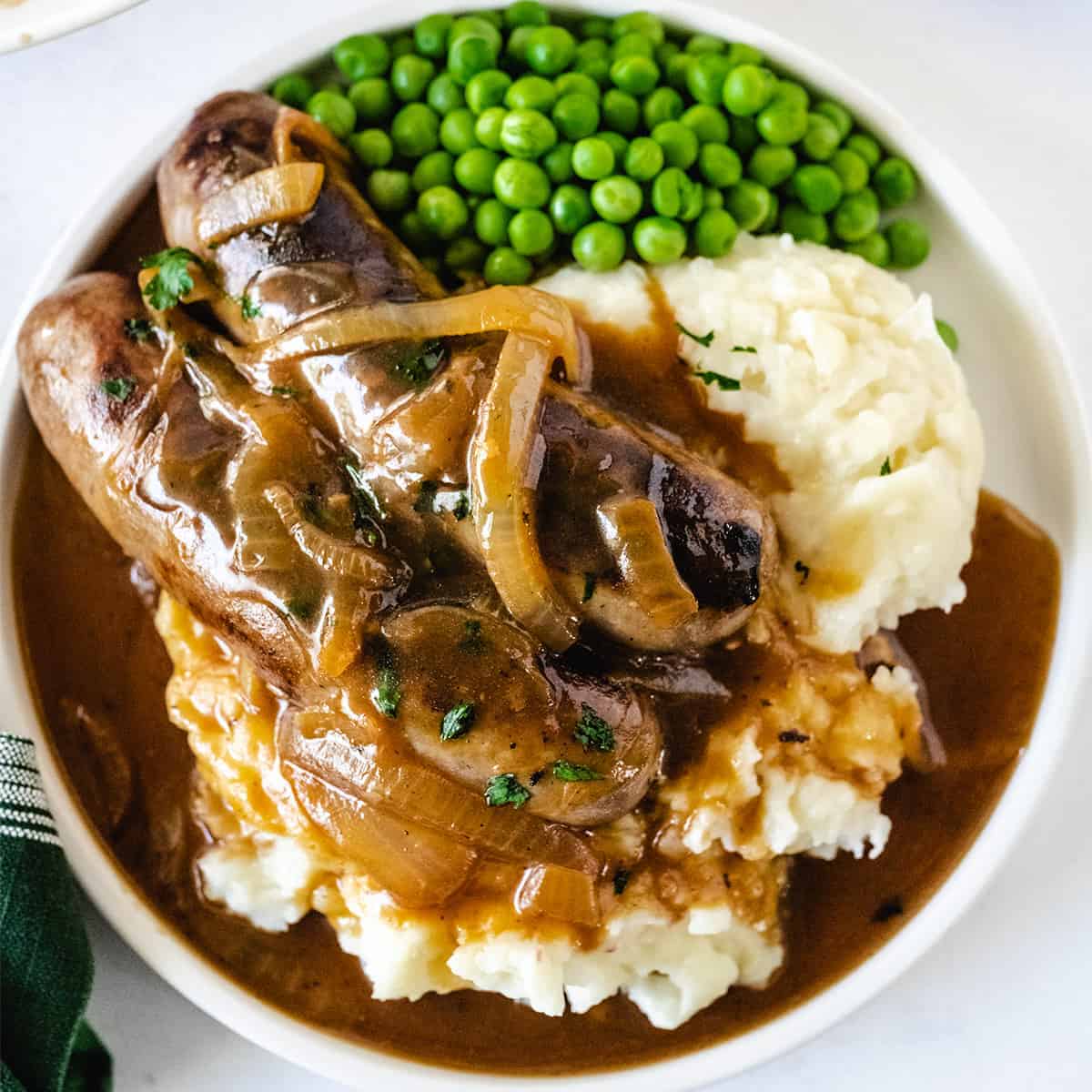 Up close overhead image bangers and onion gravy.
