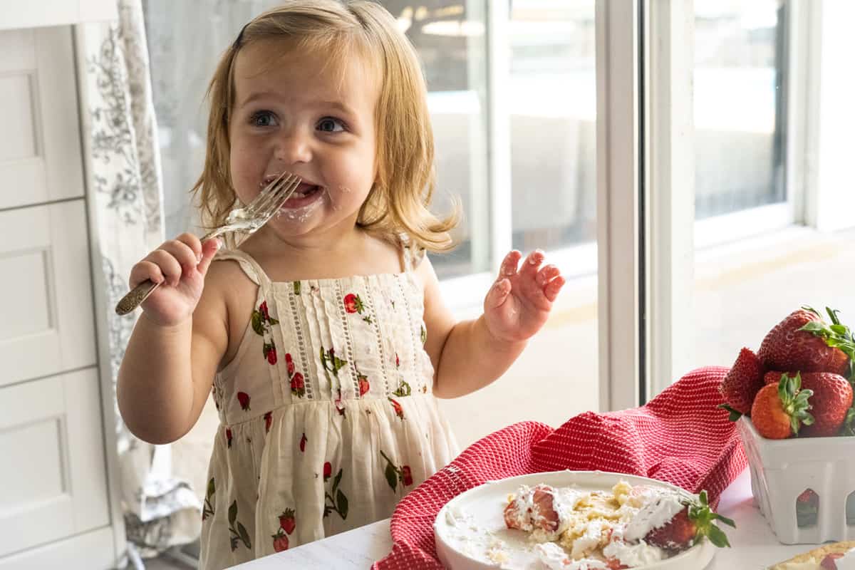 My granddaughter enjoying a bite of dessert.