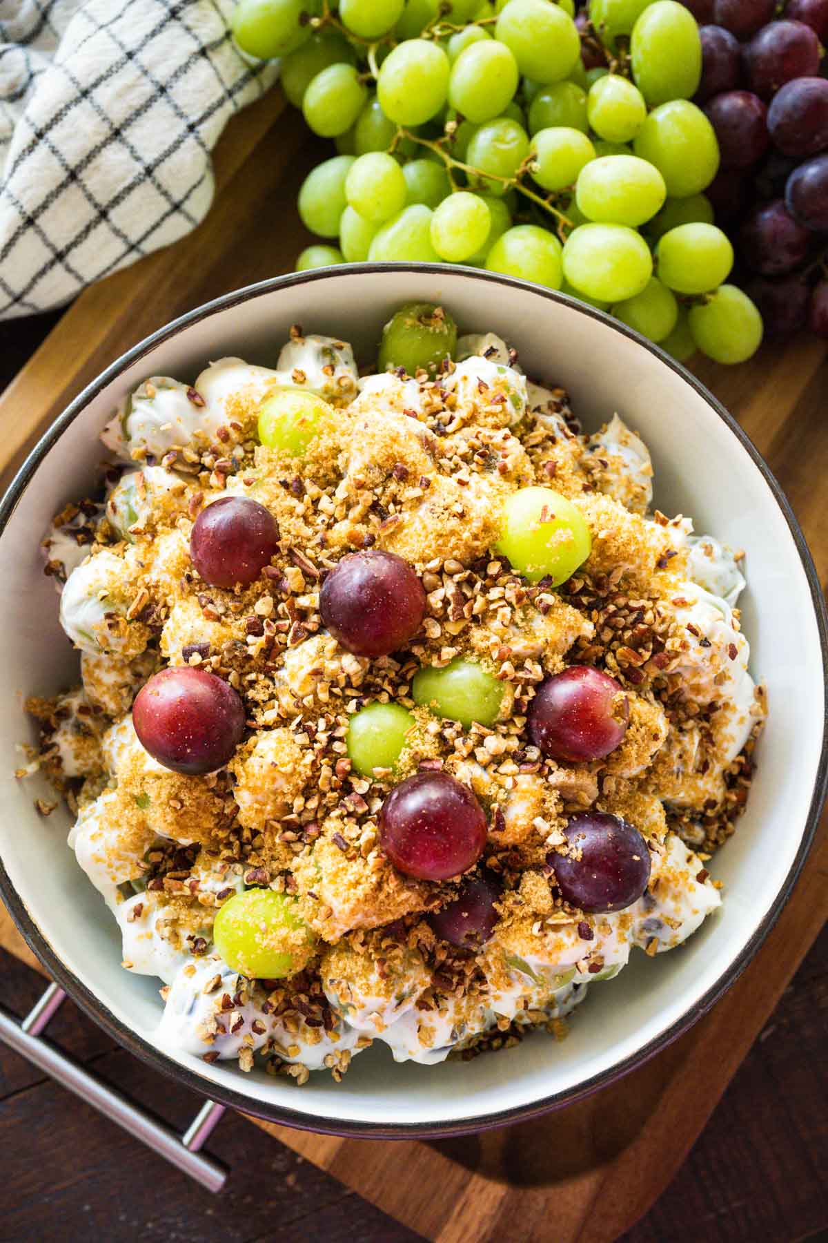 Overhead image of creamy grape salad set on a wooden table.