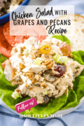 Chicken Salad with Grapes and Pecans recipe on a bed of lettuce with a bun and tomatoes