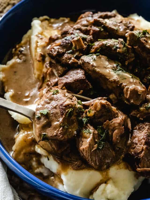 Spoon full of beef tips and gravy.