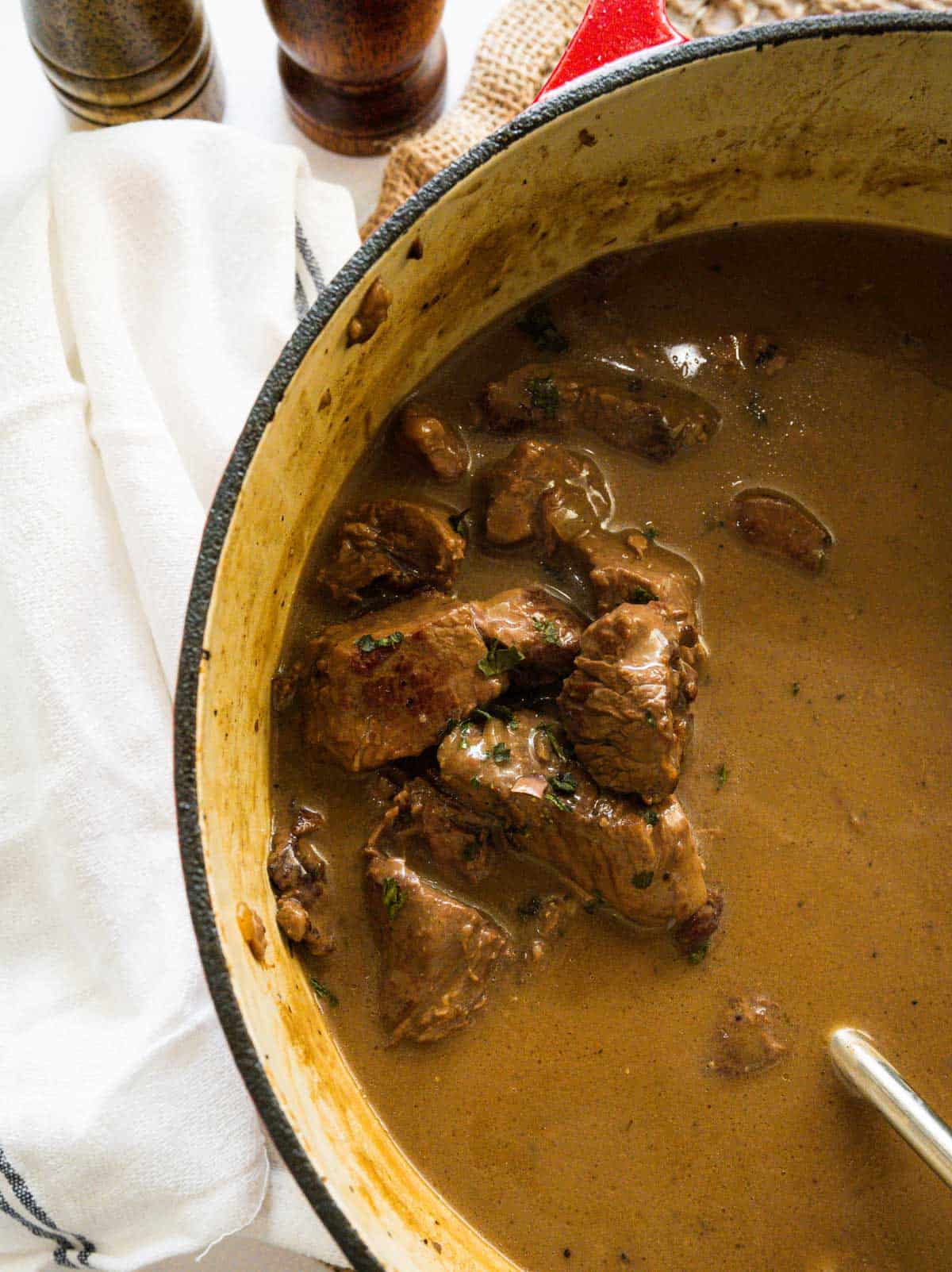 A pot full of cooked beef tips and gravy.