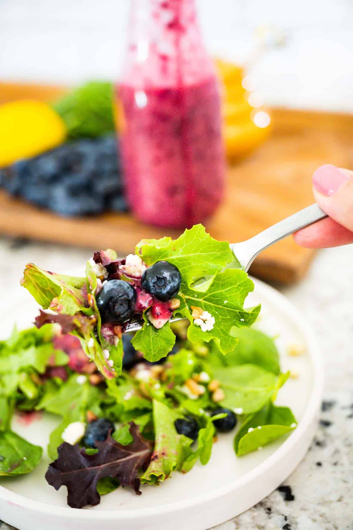 A for full of blueberry feta salad with a drizzle of blueberry vinaigrette dressing.