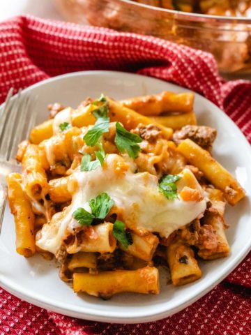 Creamy baked ziti pasta topped with melted parmesan and mozzarella cheeses.