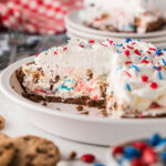 The M&m and cookie cream pie cut in the pie dish.