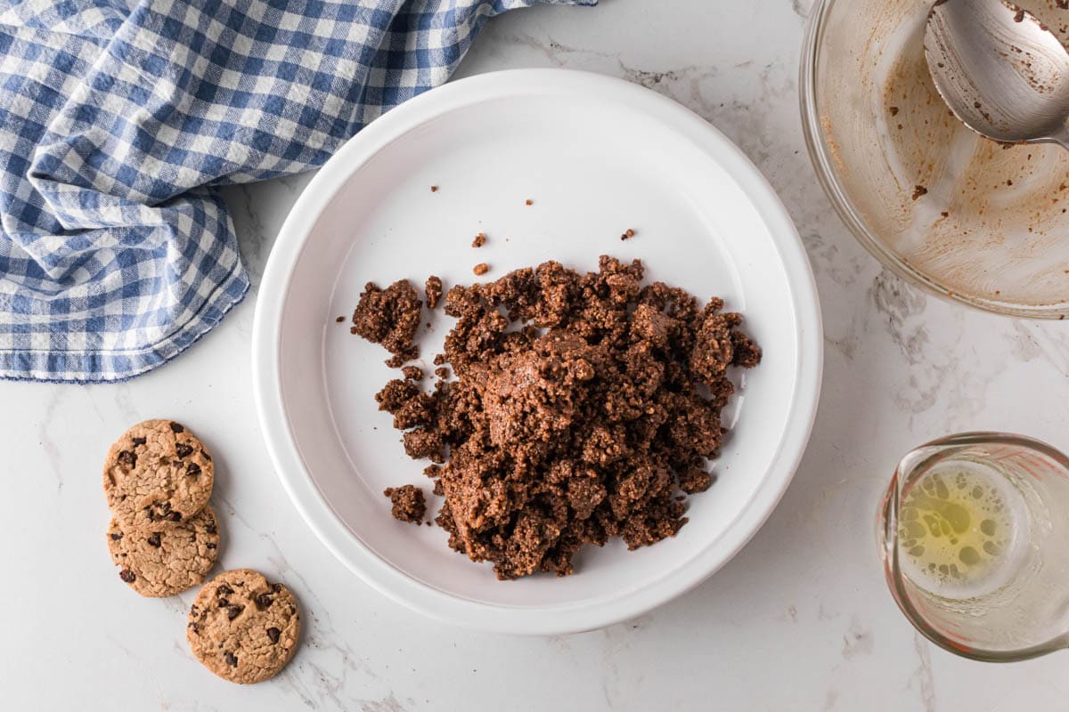 No bake cookie crumb mixture poured into a pie pan.