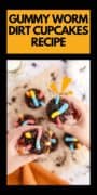 Gummy Worm Dirt Cupcake Recipe pinterest image with two hands holding cupcakes.