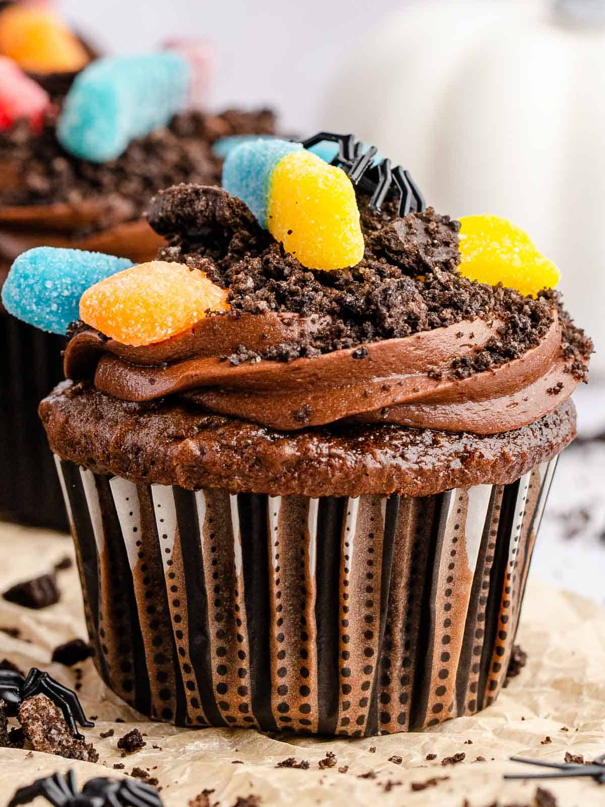 Image of an upclose single gummy worm dirt cupcake.