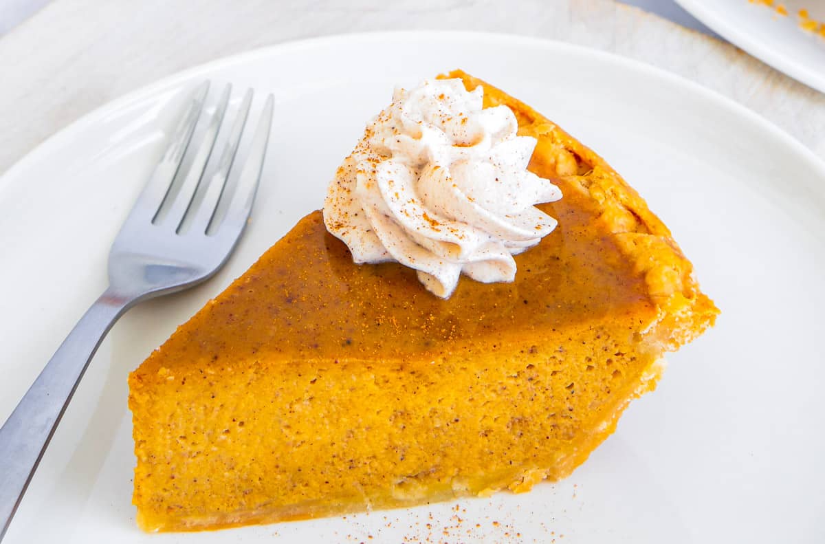 An upclose slice of easy pumpkin pie made with sweetened condensed milk.