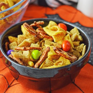 A black bowl filled with halloween chex mix.