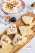 Image only of Whipped Feta Dip spread on toast on a cutting board and topped with fig.