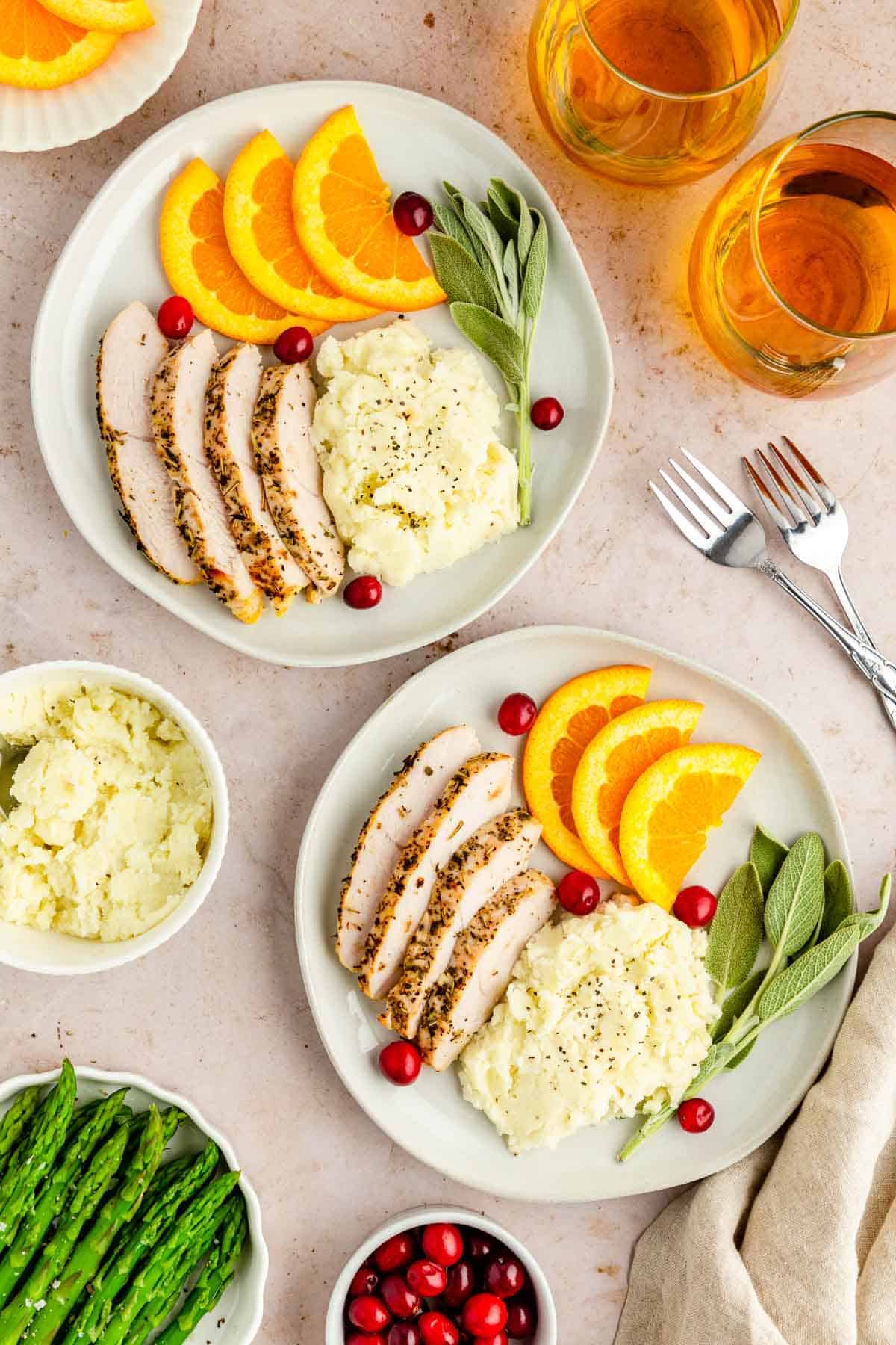 A table with two places settings of turkey dinner.