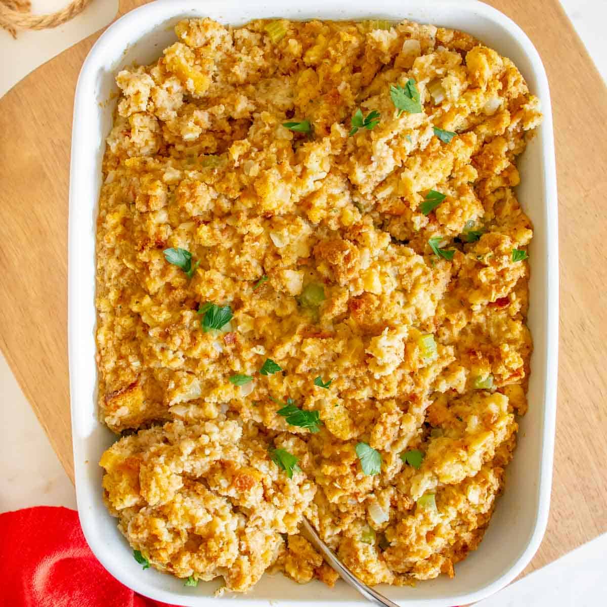 A white casserole dish filled with cornbread dressing.