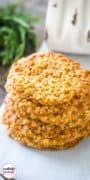 A stack of oatmeal lace cookies on parchment paper.