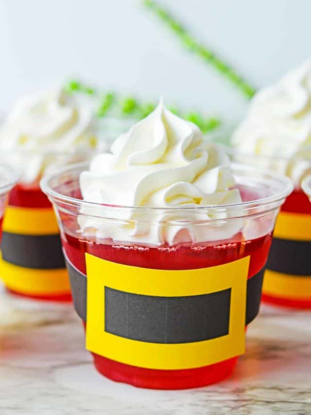 Santa Jello Cup- a clear plastic cup filled with strawberry jello wrapped with a paper Santa Belt