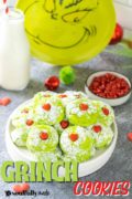 Grinch Cookies pinterest image with a plate filled with cookies and the grinch in the background.