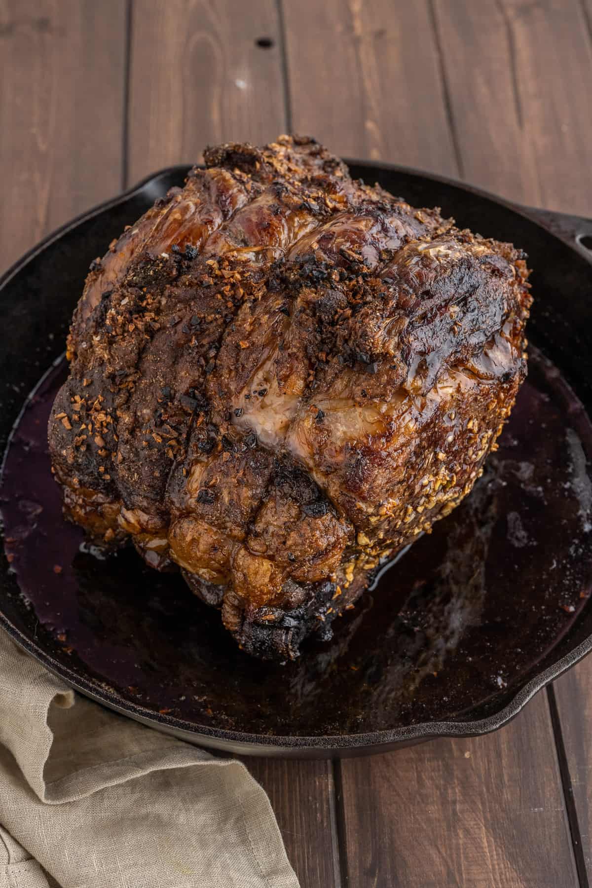 A cooked prime rib in a pan.