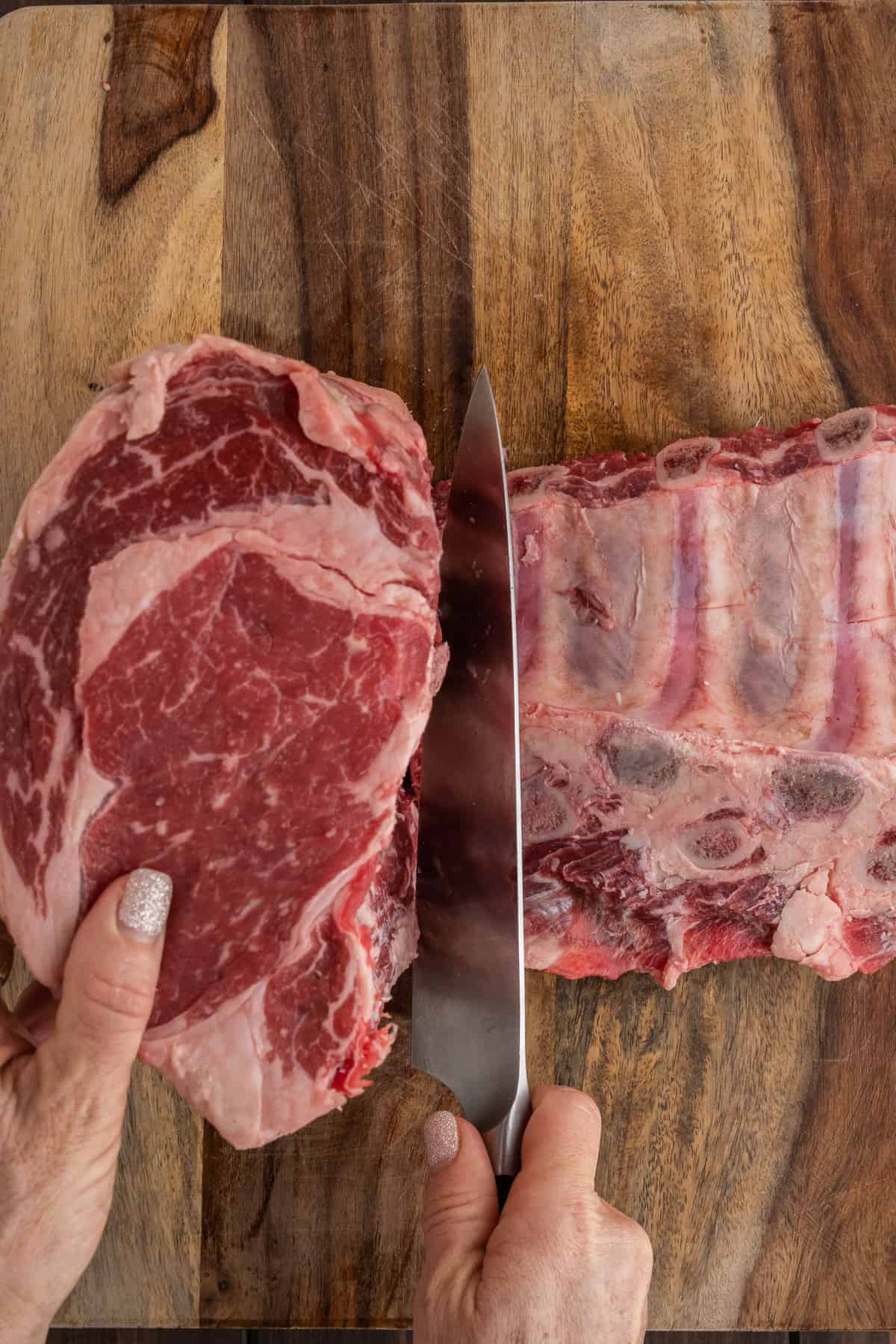 Bones being cut away from prime rib roast.