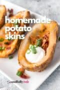 Homemade Potato Skins are deliciously crispy baked potatoes with a garlicky seasoned outside, loaded with melted cheese and crunchy bacon, and then topped with sour cream and green onions!