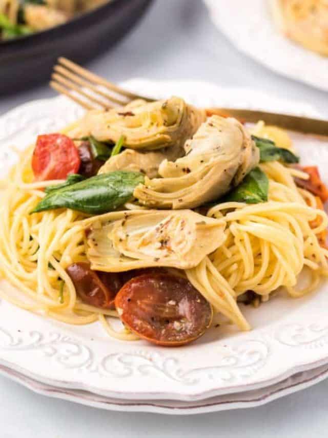 Italian Artichoke Pasta with Spinach- FB image on a white plate with a gold fork.
