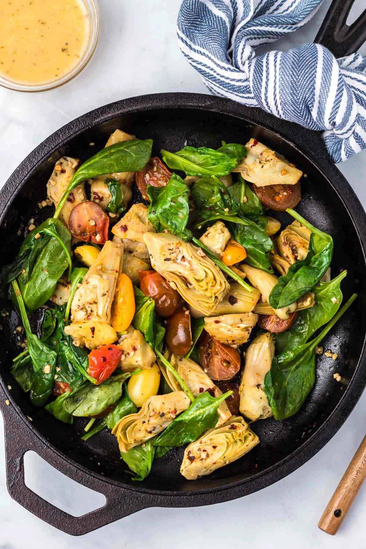 A cast iron skillet with Italian artichoke medley.