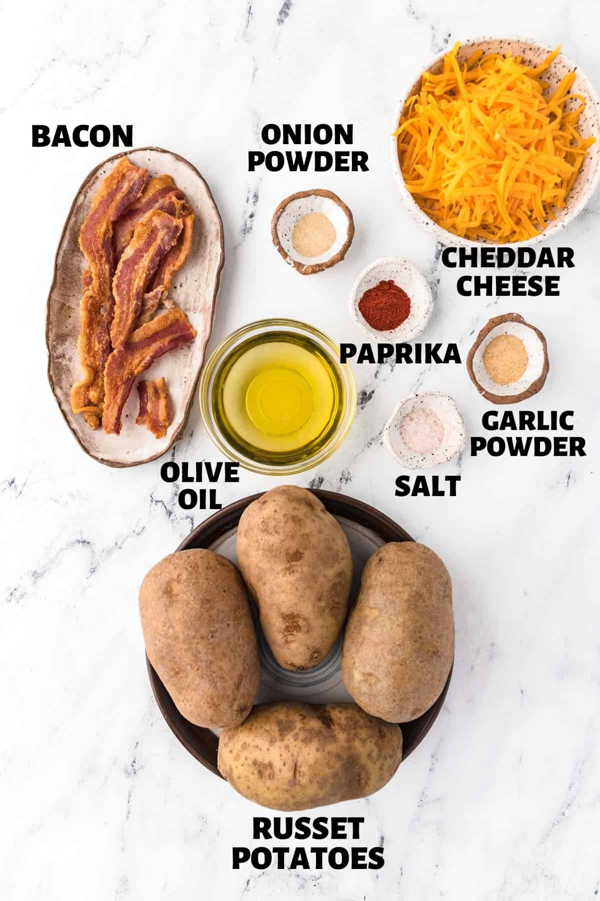 A labeled image including all the ingredients needed to make loaded baked potato skins.