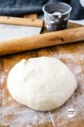 No rise pizza crust pinterest pin 4 of a ball of dough ready to roll out.