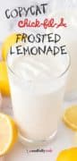 Copycat Chick-Fil-A Frosted Lemonade image of a glass filled with frosted lemonade and lemon wedges on the counter.