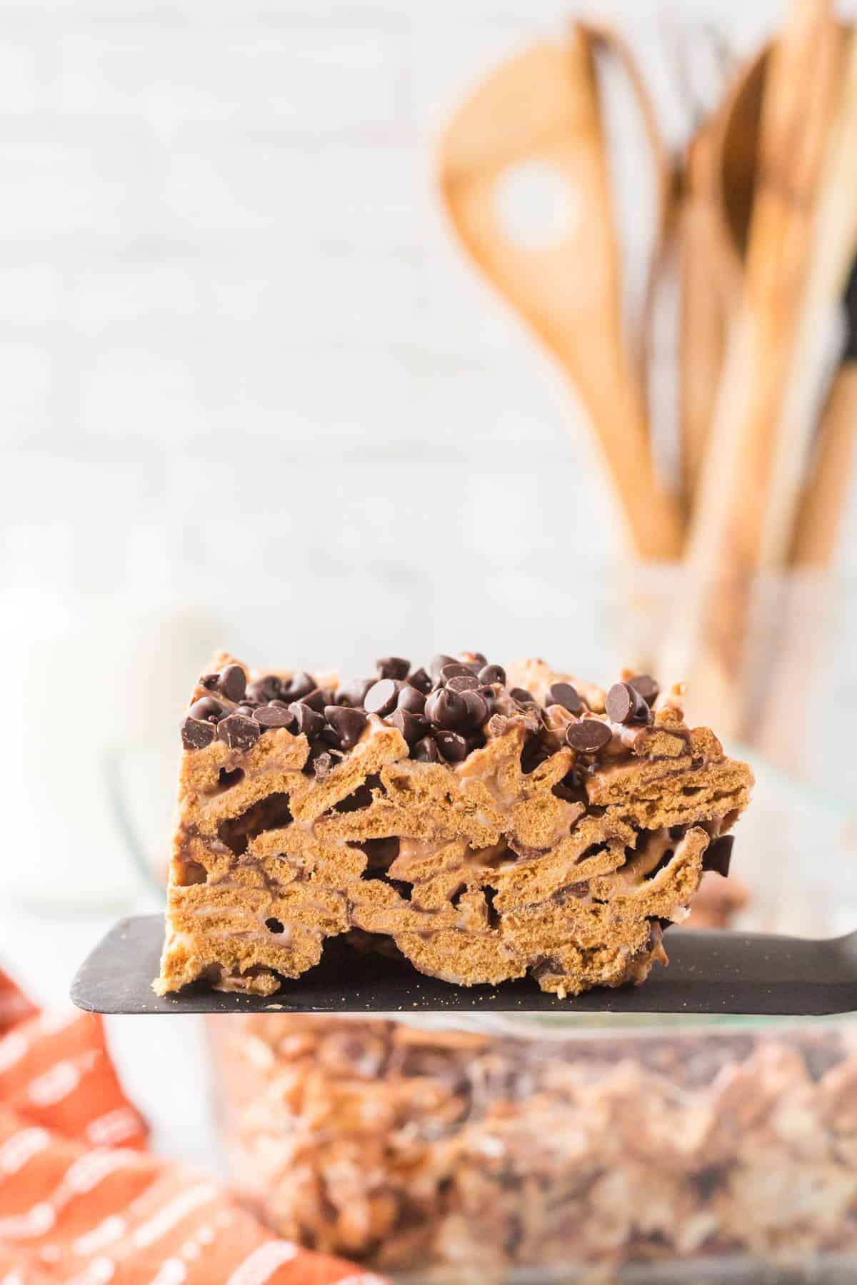 A single sliced golden graham cereal bar on a black spatula.