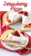 A slice of a sweet strawberry pizza on a white plate with a sliver fork.