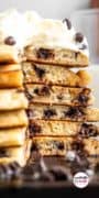 Up close stack of pancakes with a slice removed showing gooey chocolate chip melted center.